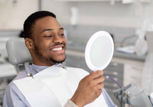 Portrait,Of,Happy,Dental,Clinic,Patient,Looking,At,Mirror,After